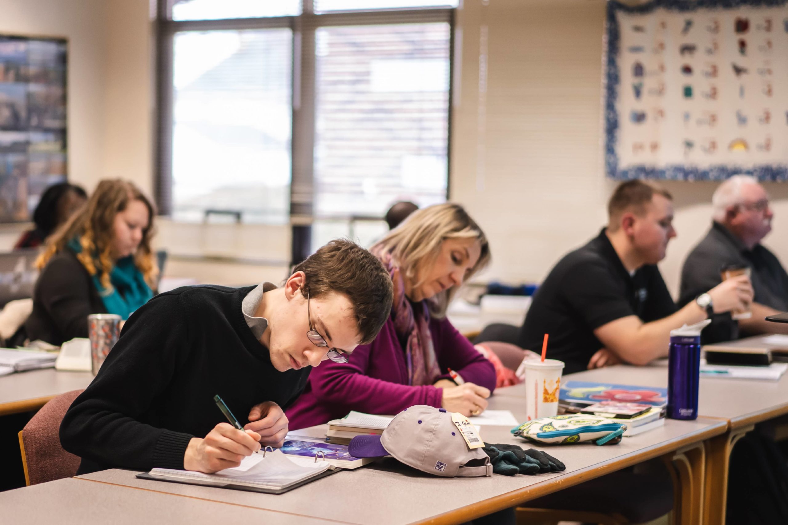 students in classroom taking notes