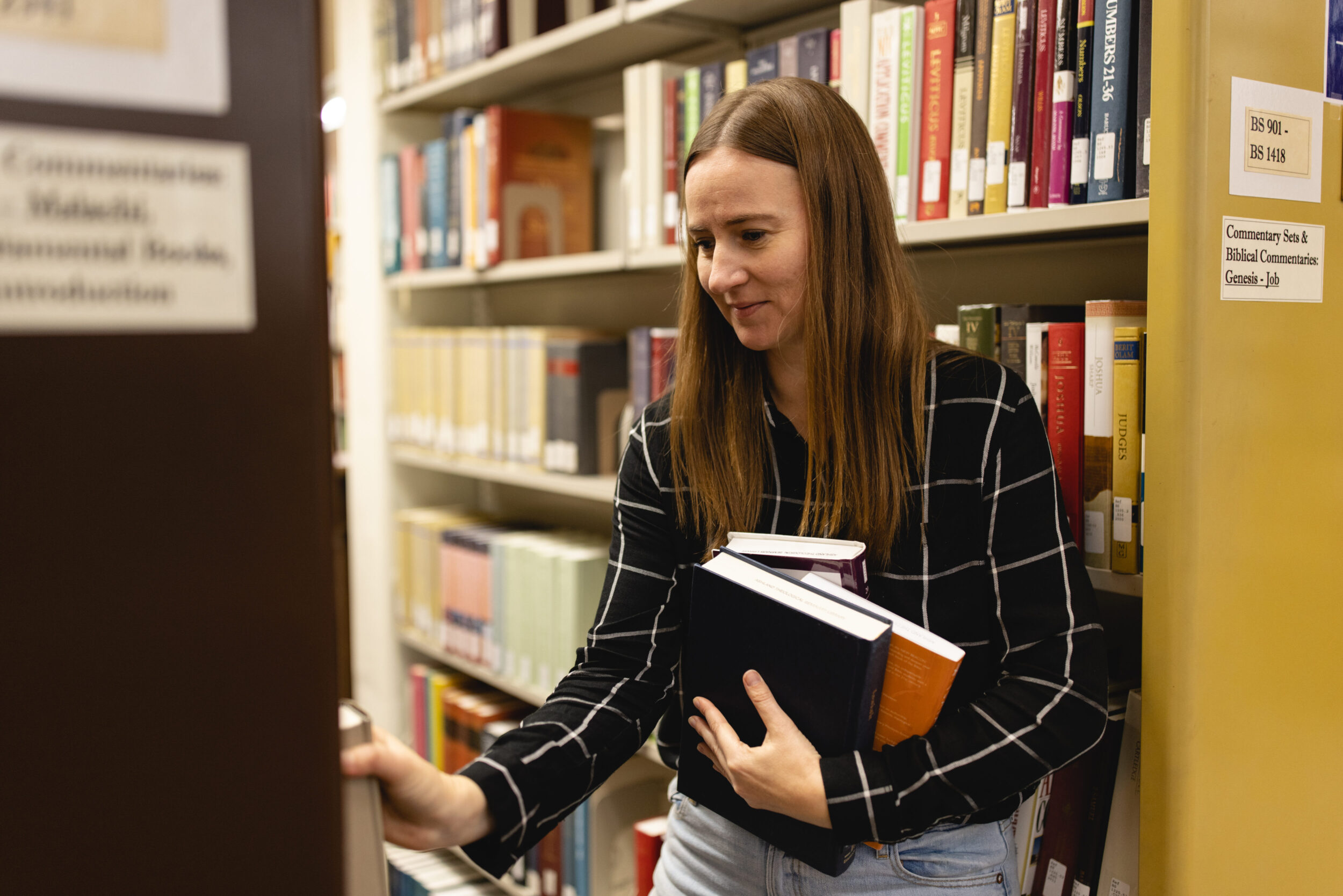 student finding books in library