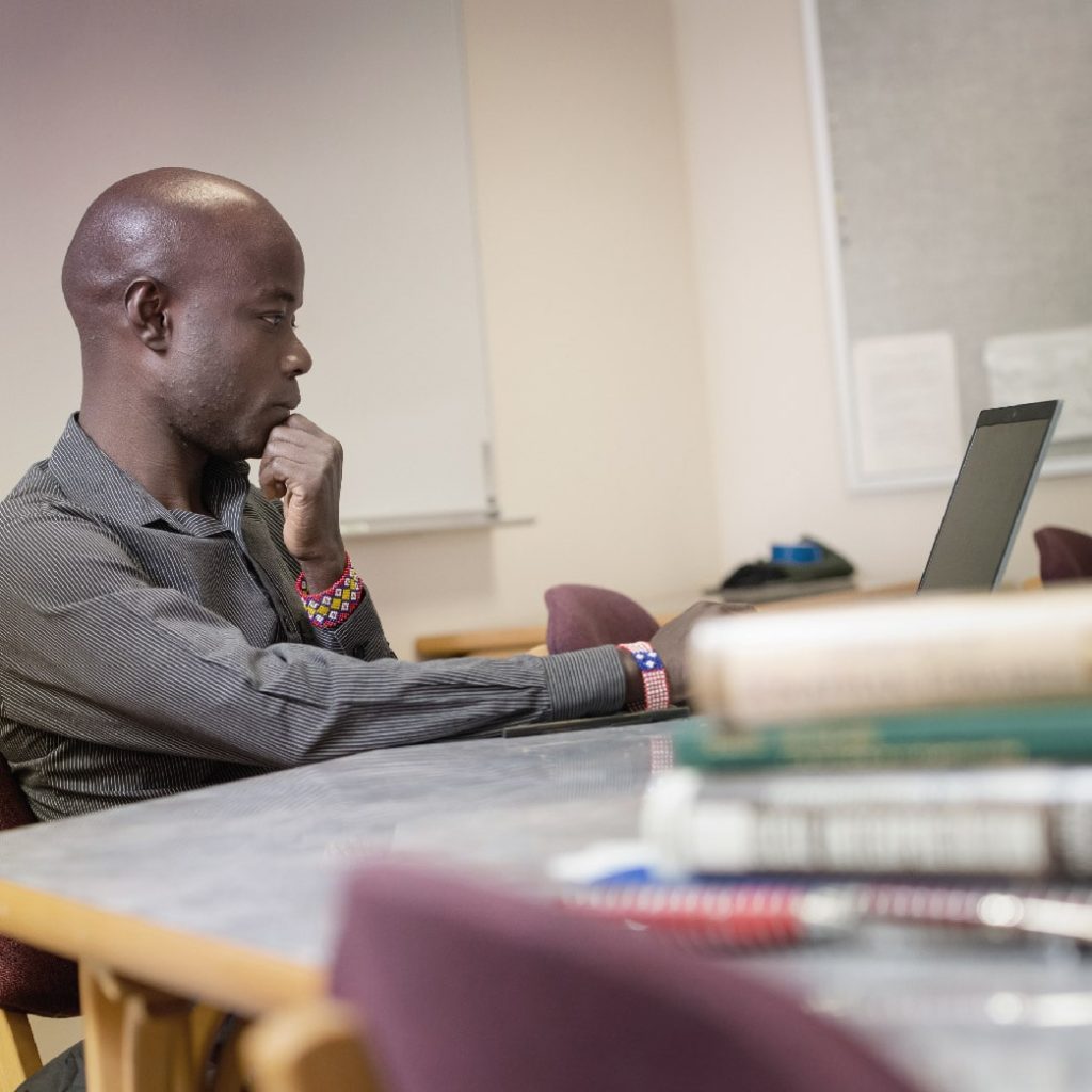student in classroom working on computer
