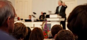 church service with pastor preaching in background